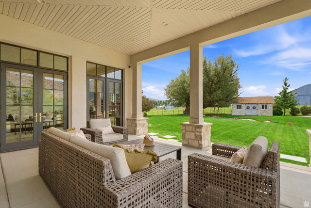 71 Farm Road Midway, UT 84049 - Photo 87 of 92 Covered patio with a slatted ceiling, stone-clad columns, and a concrete surface