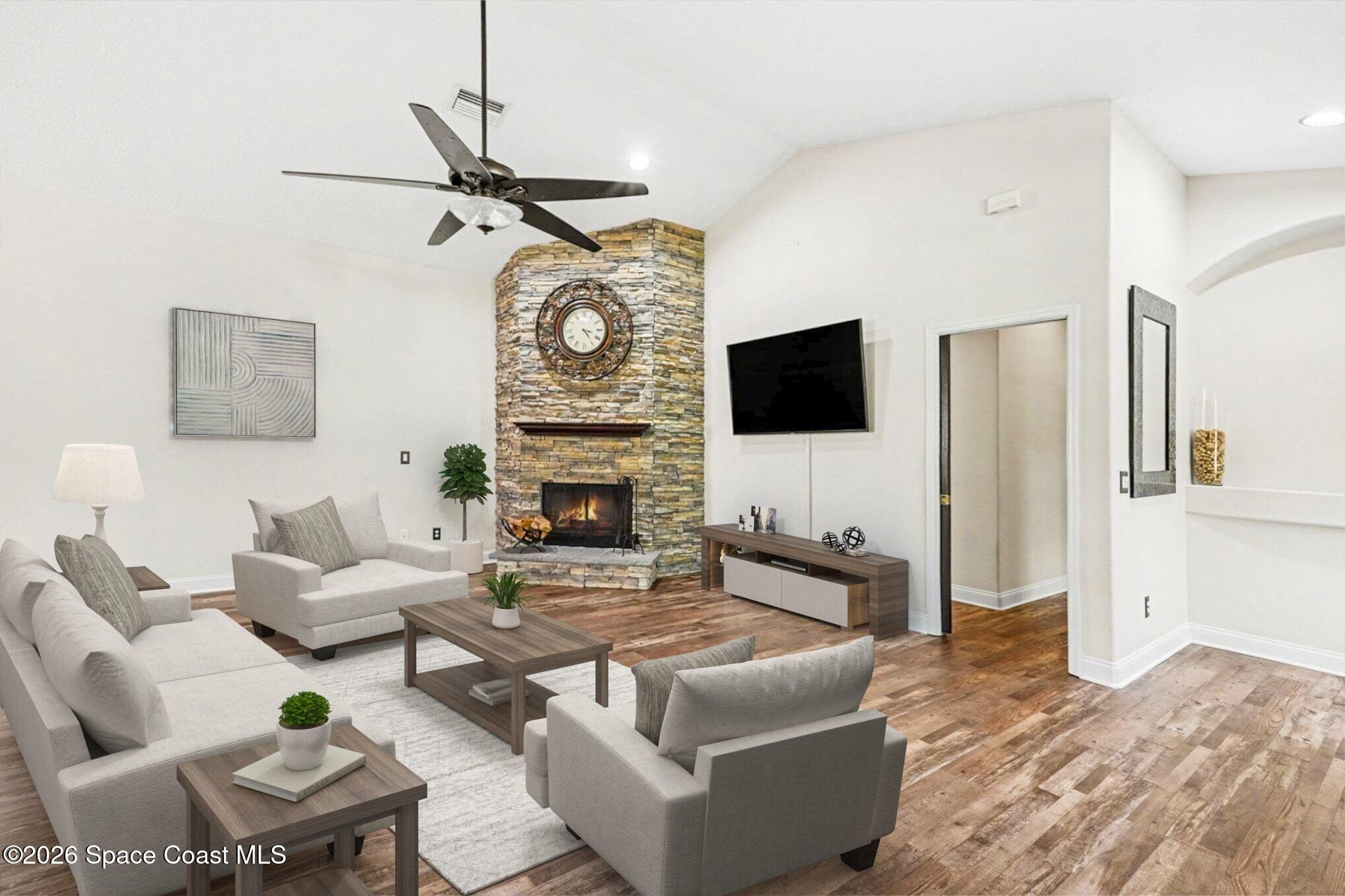 1355 Dalbora Road Merritt Island, FL 32953 - Photo 12 of 37 a living room with furniture a flat screen tv and a fireplace