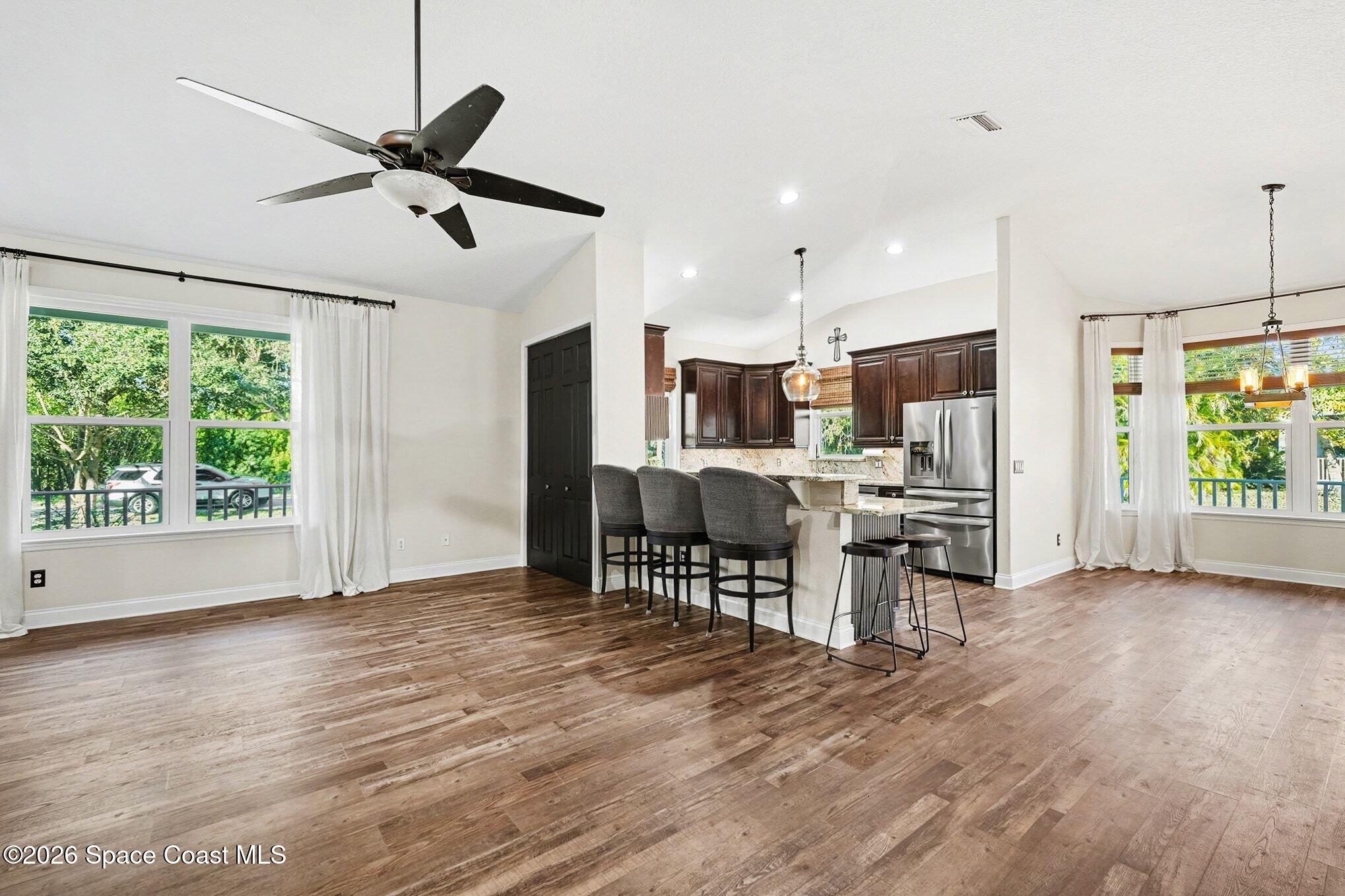 1355 Dalbora Road Merritt Island, FL 32953 - Photo 15 of 37 a view of kitchen with stainless steel appliances wooden floor dining table and chairs