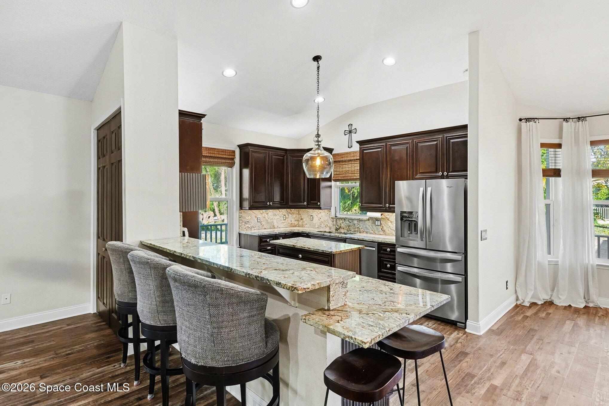 1355 Dalbora Road Merritt Island, FL 32953 - Photo 16 of 37 a kitchen with stainless steel appliances a refrigerator and a stove top oven