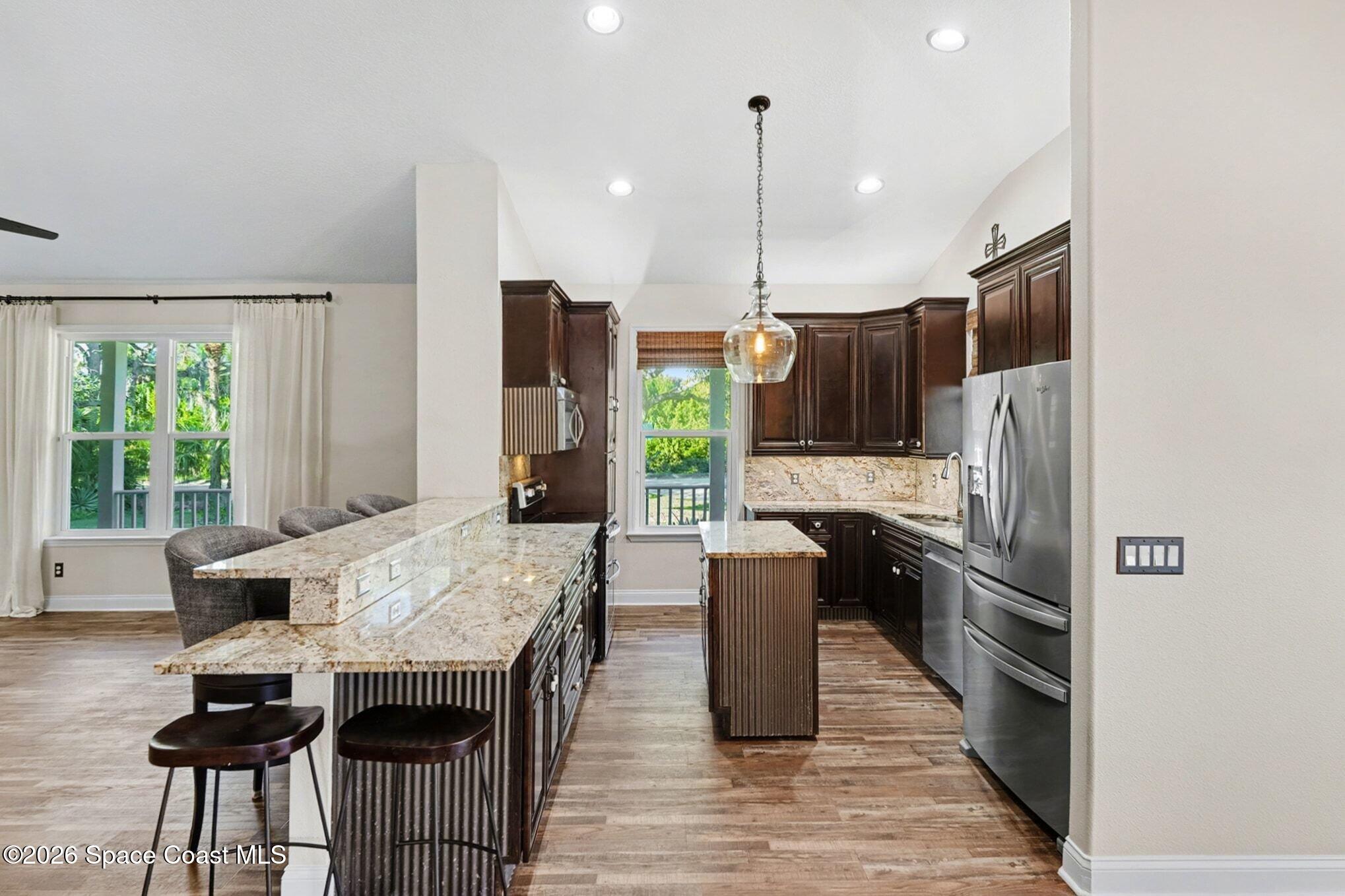 1355 Dalbora Road Merritt Island, FL 32953 - Photo 18 of 37 a kitchen with granite countertop a refrigerator and a stove top oven