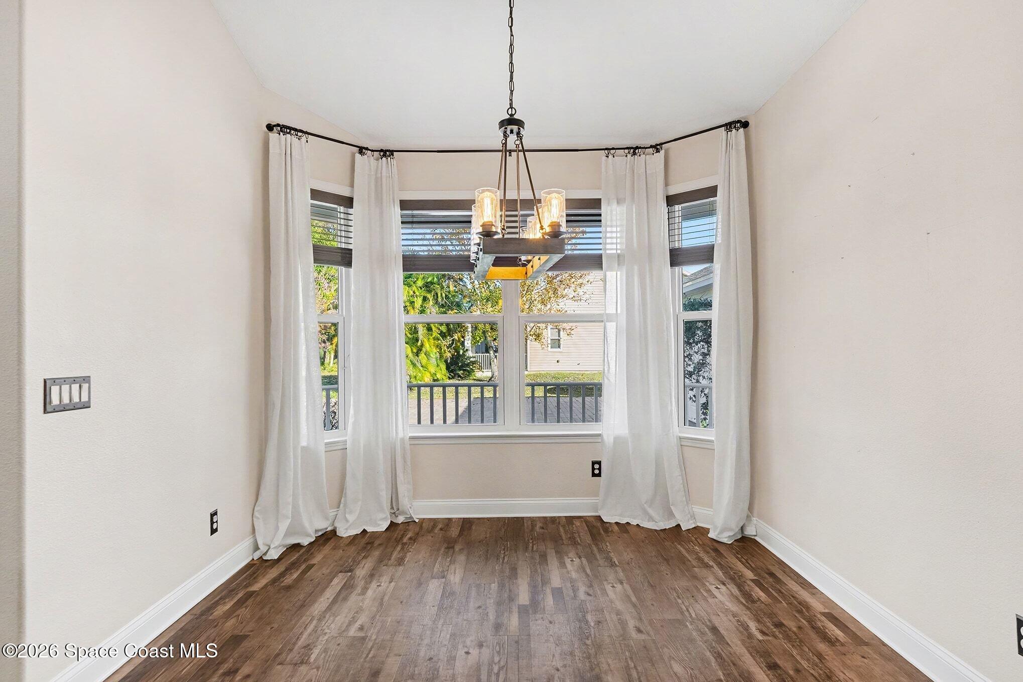 1355 Dalbora Road Merritt Island, FL 32953 - Photo 20 of 37 a view of empty room with wooden floor and fan