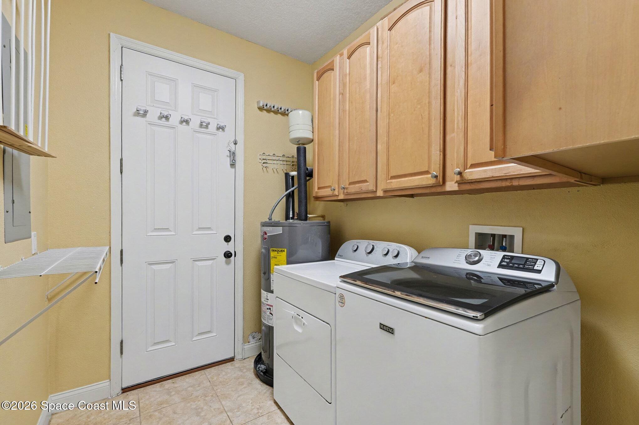 1355 Dalbora Road Merritt Island, FL 32953 - Photo 25 of 37 a utility room with dryer and washer