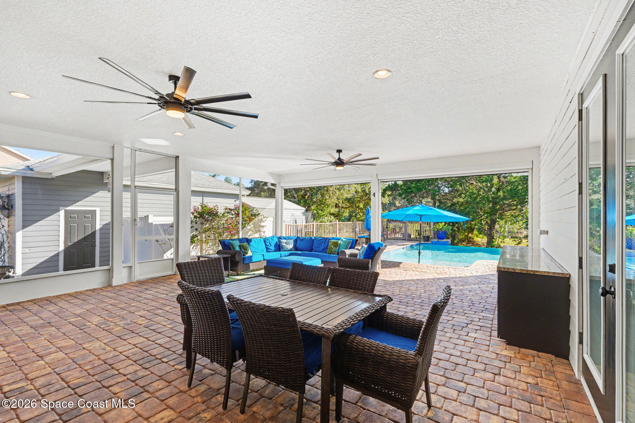 1355 Dalbora Road Merritt Island, FL 32953 - Photo 28 of 37 a view of a dining room with furniture large windows and wooden floor