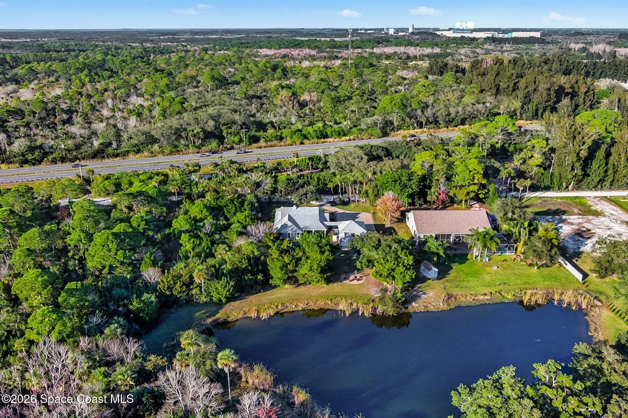 1355 Dalbora Road Merritt Island, FL 32953 - Photo 33 of 37 an aerial view of residential houses with outdoor space and trees