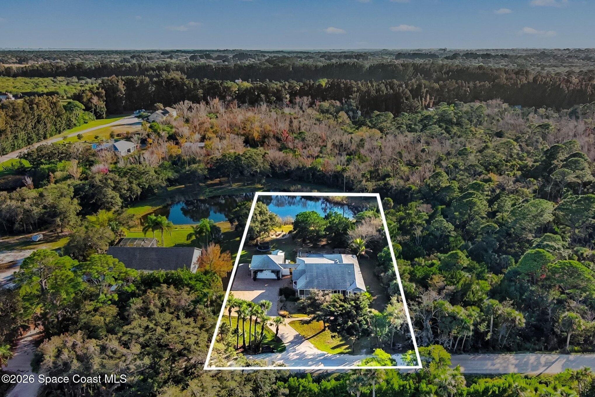 1355 Dalbora Road Merritt Island, FL 32953 - Photo 34 of 37 an aerial view of a house with a yard