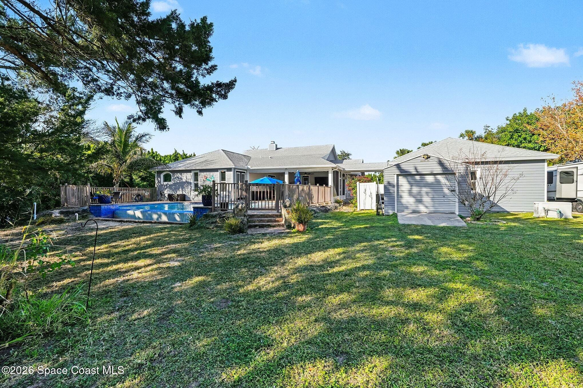 1355 Dalbora Road Merritt Island, FL 32953 - Photo 35 of 37 a front view of a house with a garden