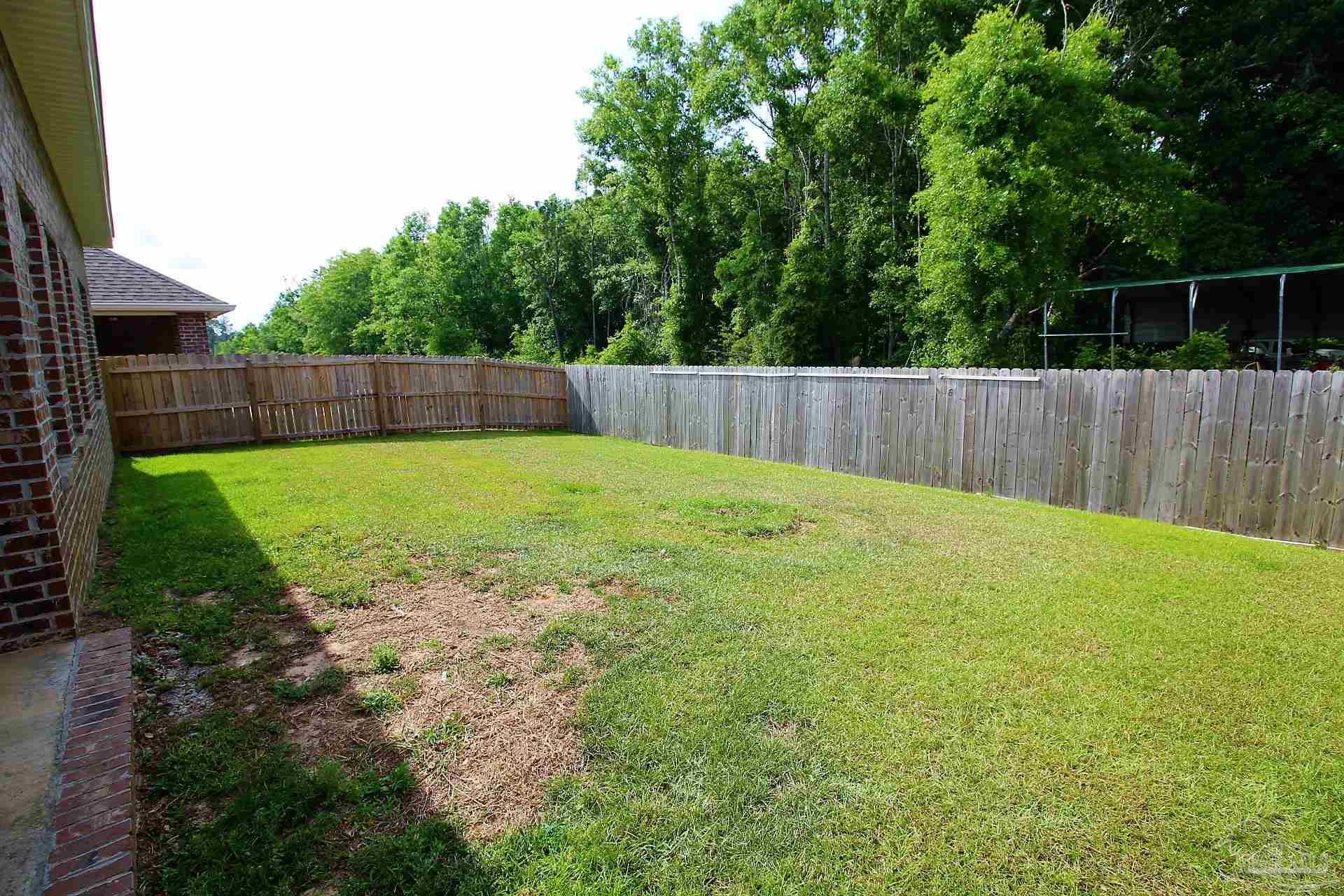 8006 Burnside Loop Pensacola, FL 32526 - Photo 22 of 22 a view of a backyard with a small cabin