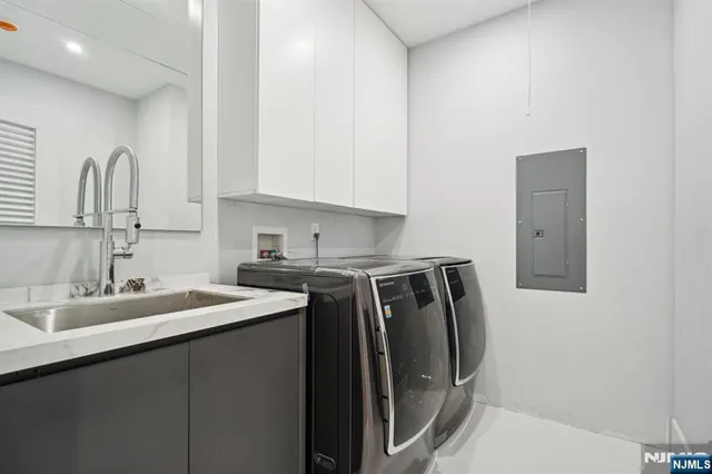 a kitchen with stainless steel appliances granite countertop a sink and cabinets