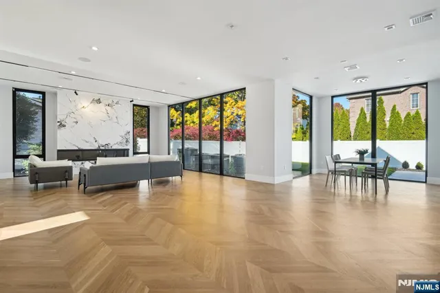 a living room with furniture and large windows