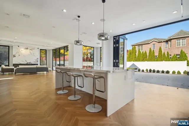 a large white kitchen with a large window