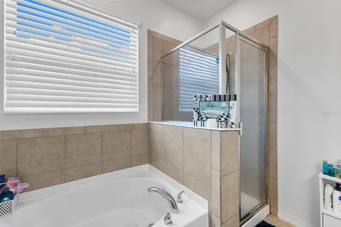 a bathroom with a tub and shower