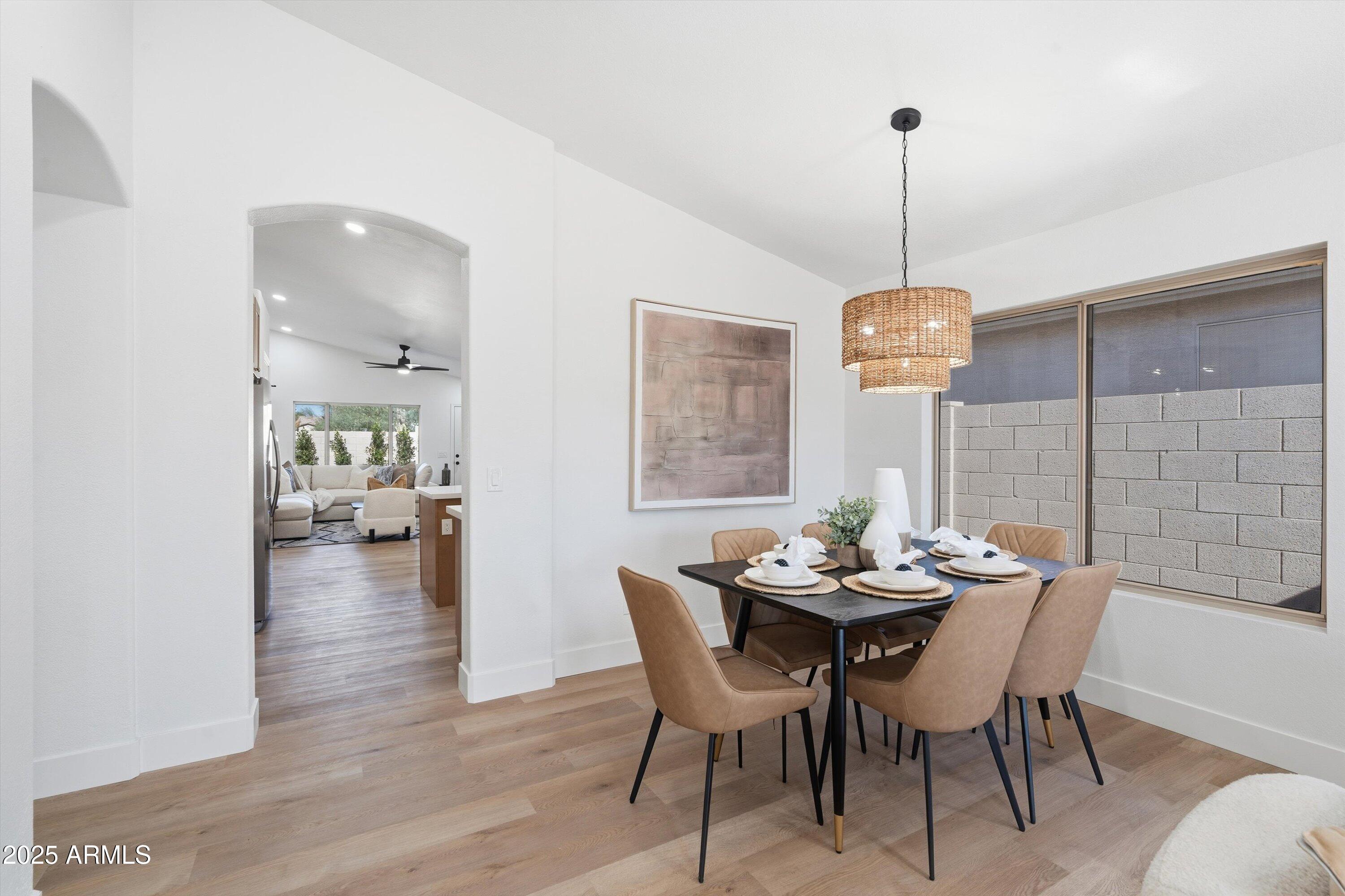 4438 East Rowel Road Phoenix, AZ 85050 - Photo 11 of 30 a dining room with furniture wooden floor a chandelier and a rug