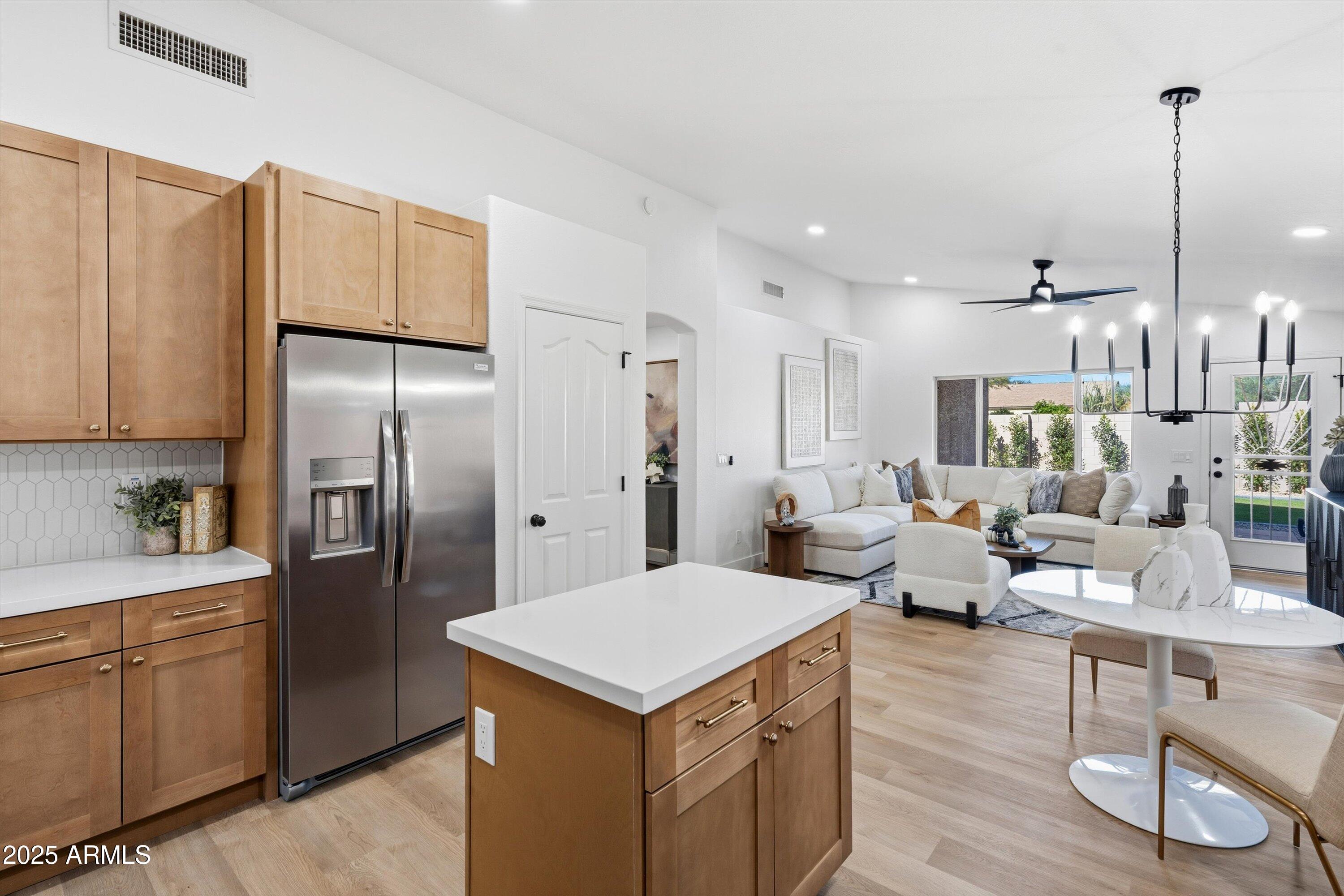 4438 East Rowel Road Phoenix, AZ 85050 - Photo 12 of 30 a kitchen with white cabinets and refrigerator