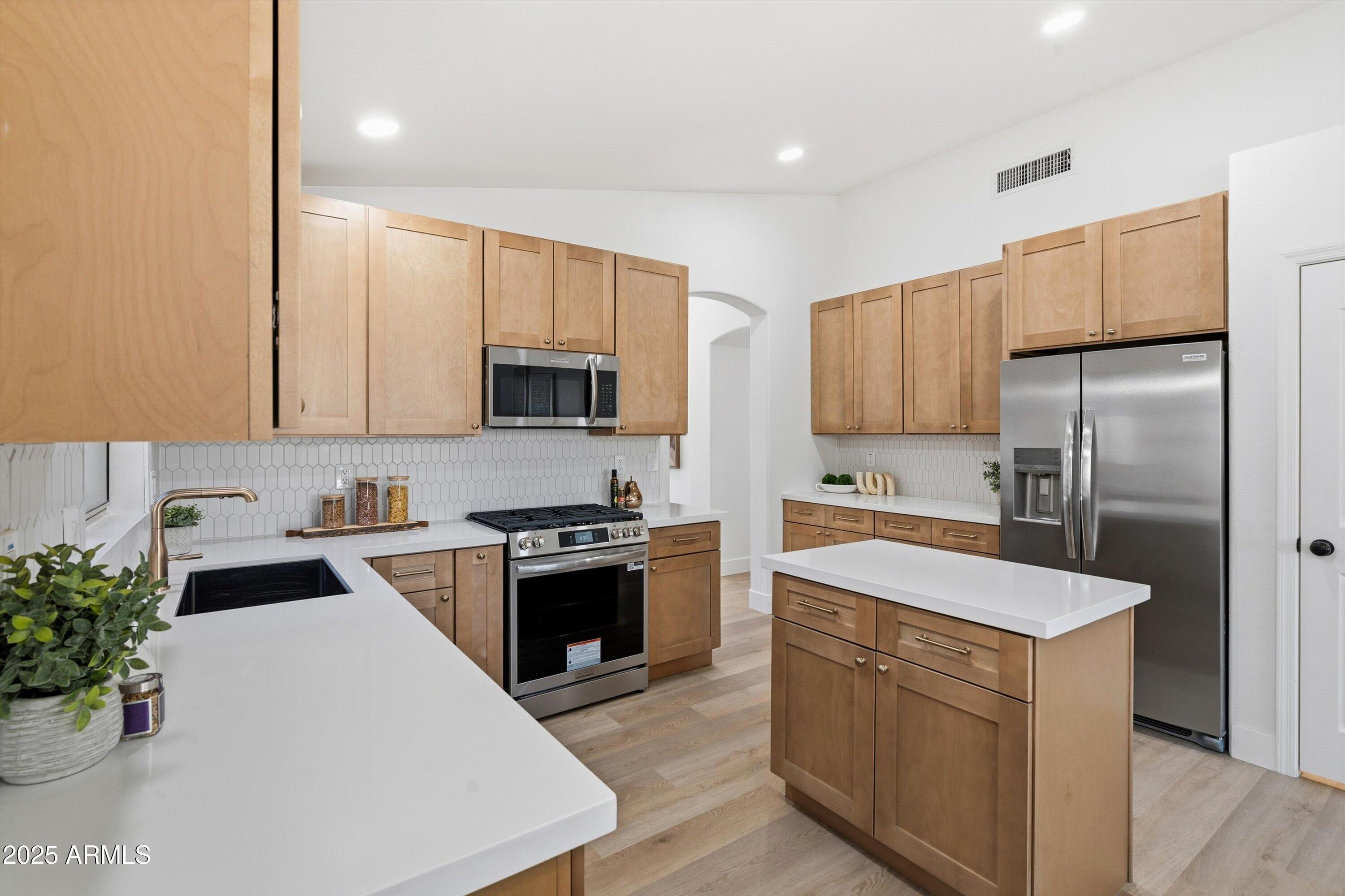 4438 East Rowel Road Phoenix, AZ 85050 - Photo 13 of 30 a kitchen with granite countertop a sink stove and refrigerator