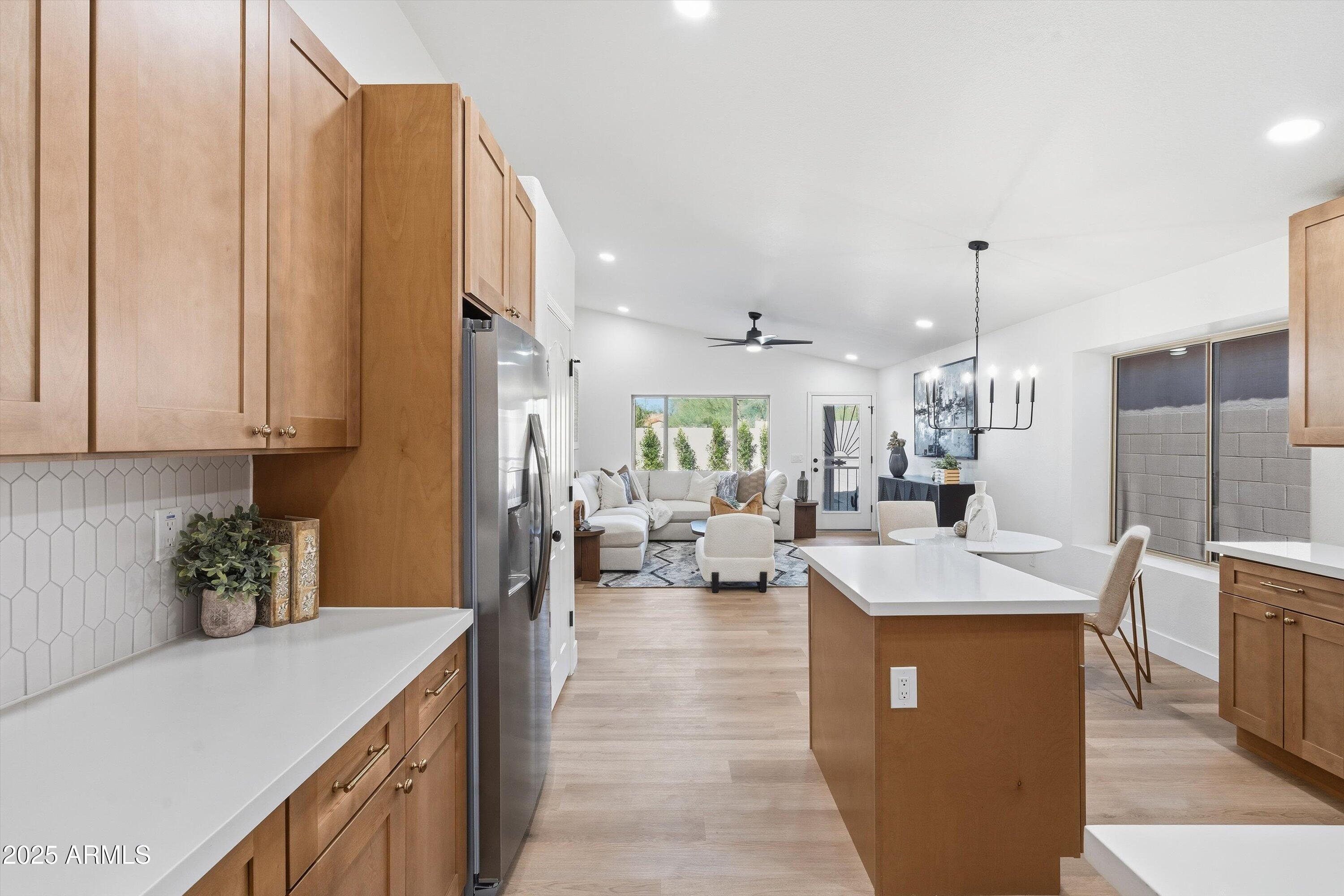 4438 East Rowel Road Phoenix, AZ 85050 - Photo 15 of 30 a kitchen with stainless steel appliances granite countertop a sink counter space and a view of living room