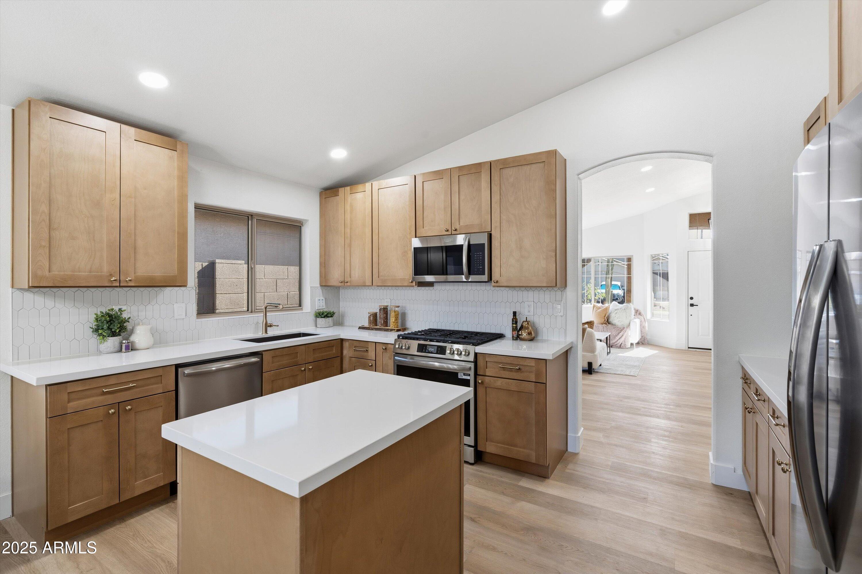 4438 East Rowel Road Phoenix, AZ 85050 - Photo 16 of 30 a kitchen with a sink a counter top space stainless steel appliances and cabinets