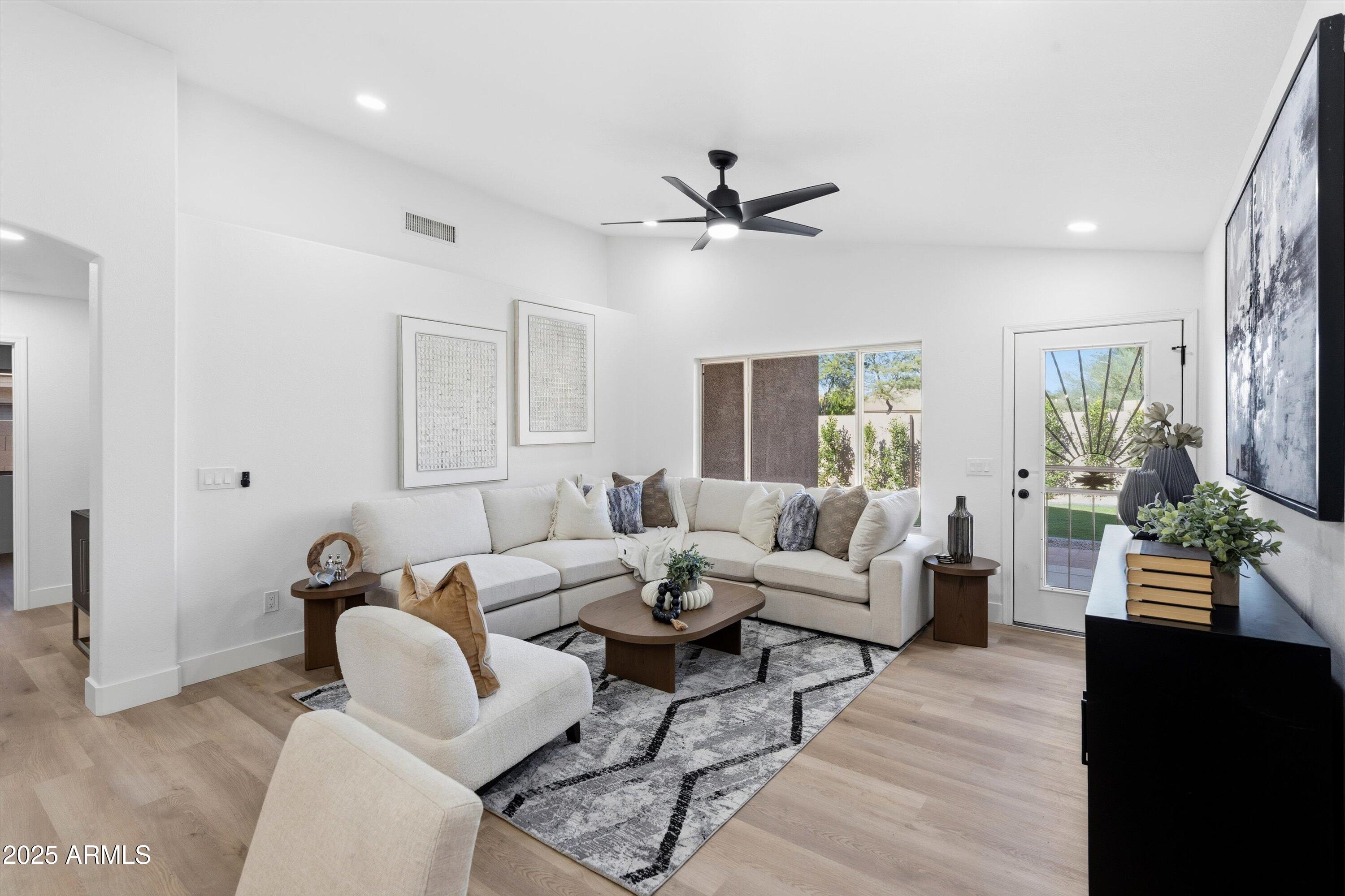 4438 East Rowel Road Phoenix, AZ 85050 - Photo 17 of 30 a living room with furniture and a wooden floor