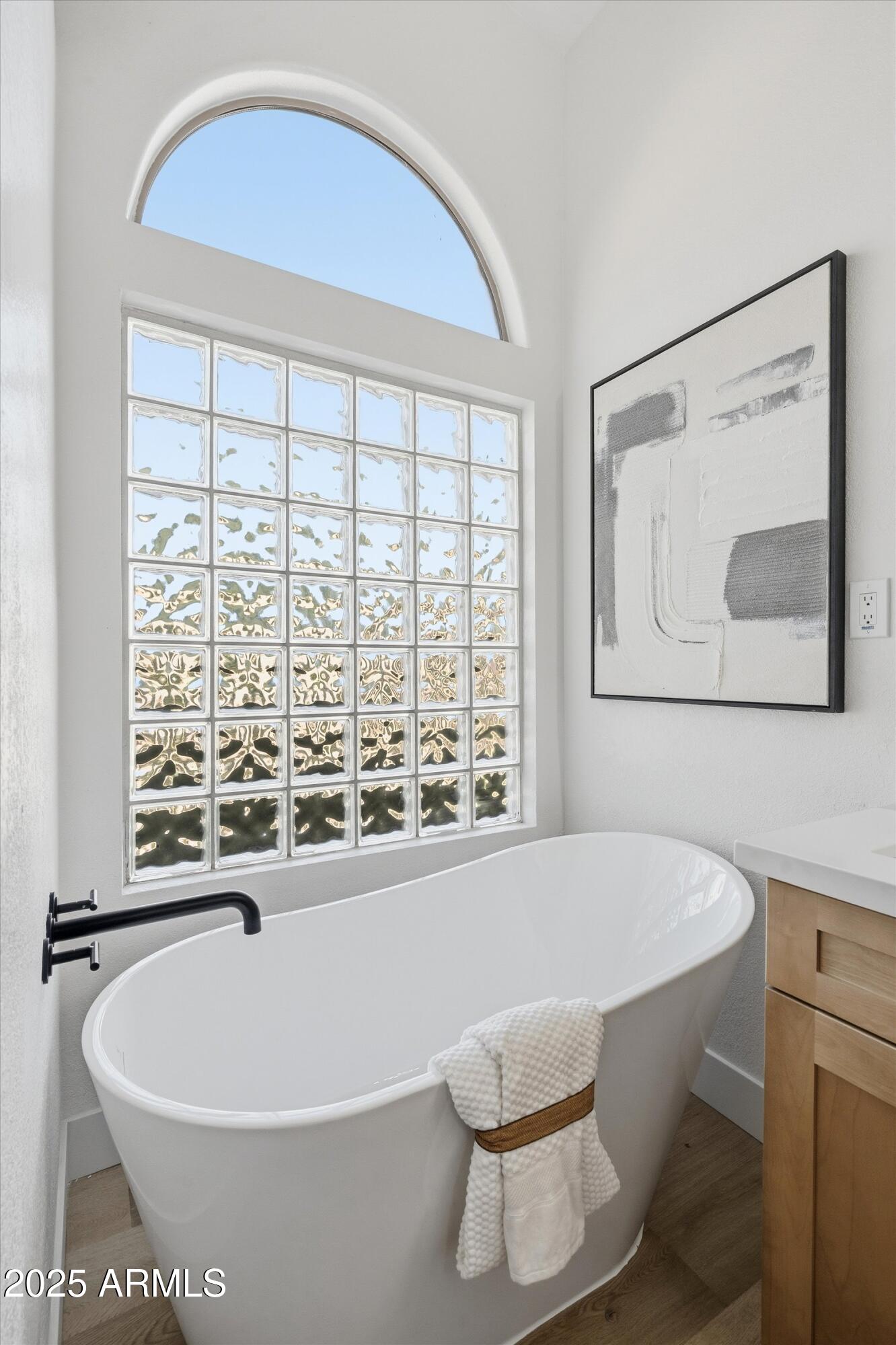 4438 East Rowel Road Phoenix, AZ 85050 - Photo 21 of 30 a bath tub sitting next to a white toilet