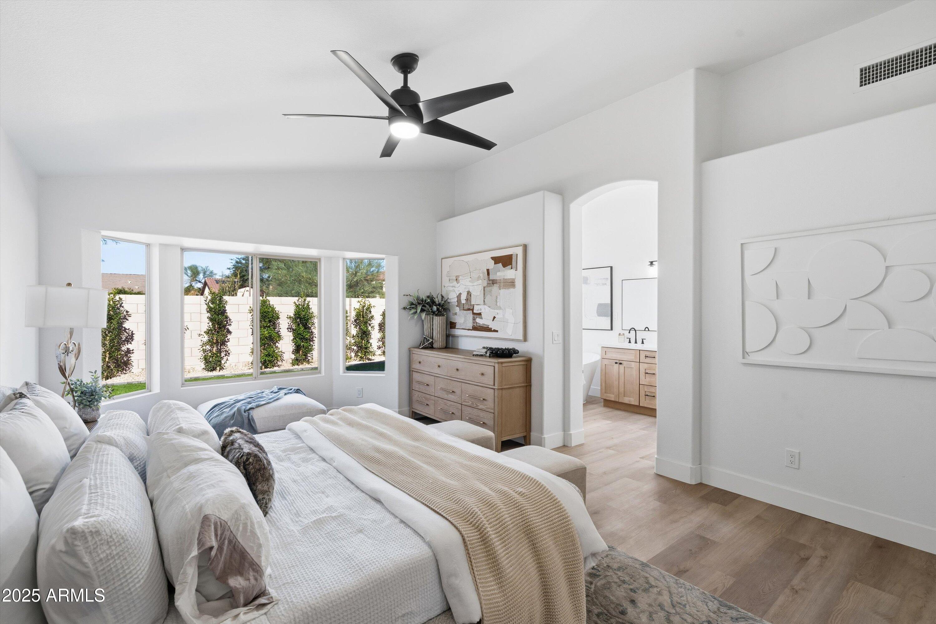 4438 East Rowel Road Phoenix, AZ 85050 - Photo 4 of 30 a bedroom with a large bed and a large window