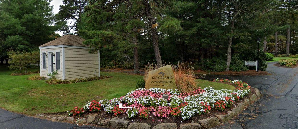 105 Shellback Way, Unit P Mashpee, MA 02649 - Photo 23 of 29 a front view of a house with a yard and fountain