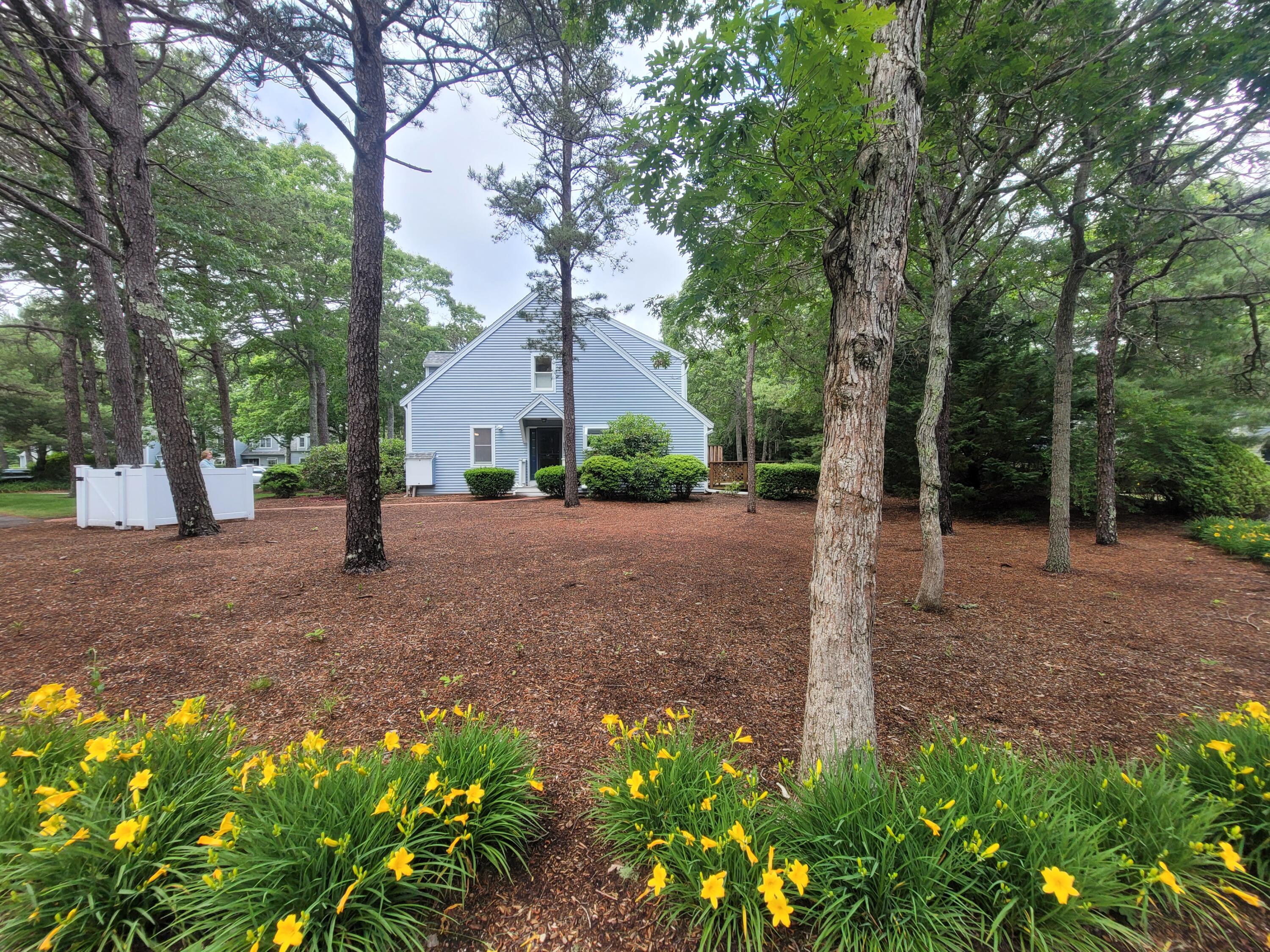 105 Shellback Way, Unit P Mashpee, MA 02649 - Photo 26 of 29 a view of a house with a tree in the background