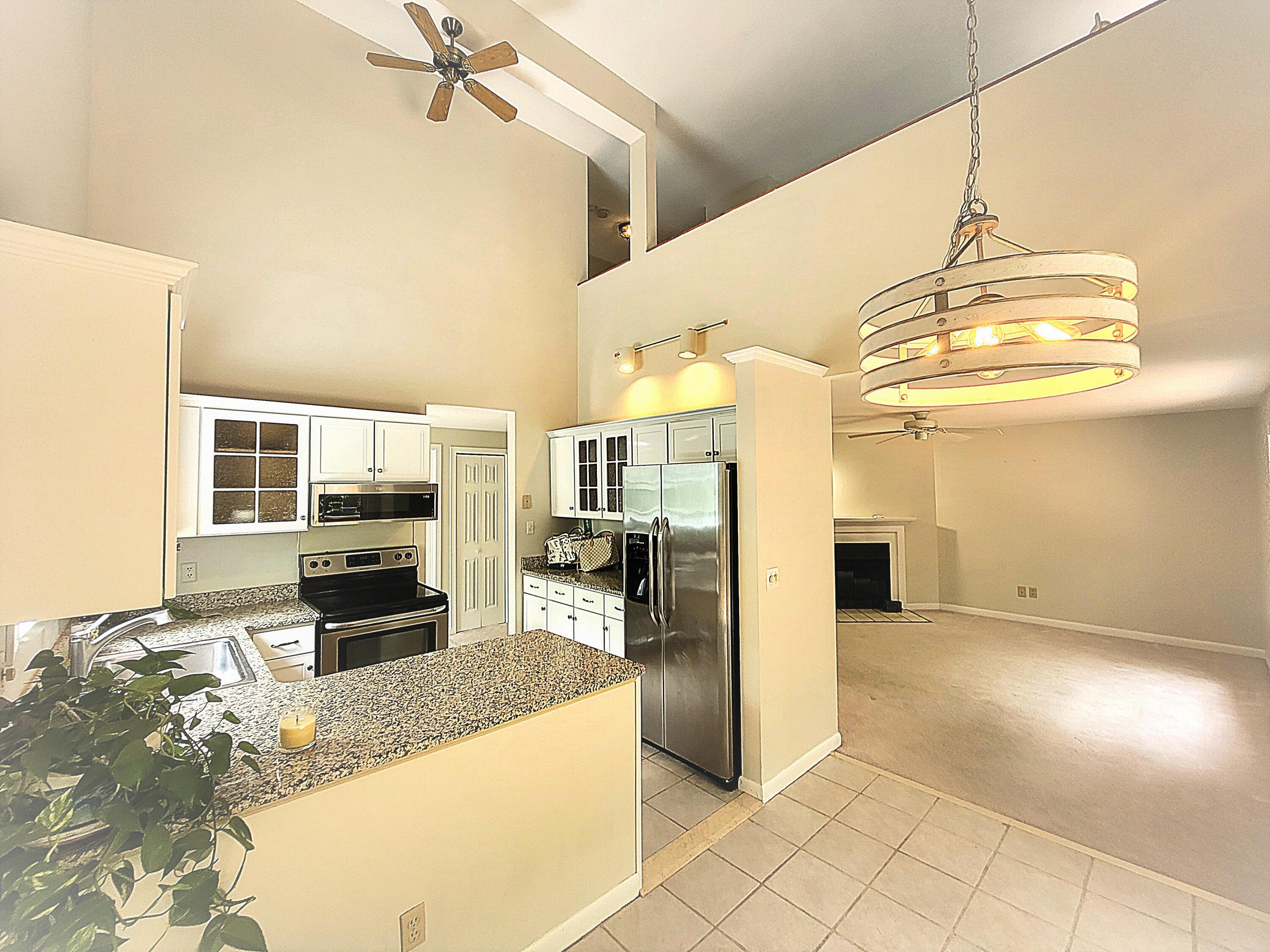105 Shellback Way, Unit P Mashpee, MA 02649 - Photo 3 of 29 a kitchen with stainless steel appliances granite countertop a sink and cabinets