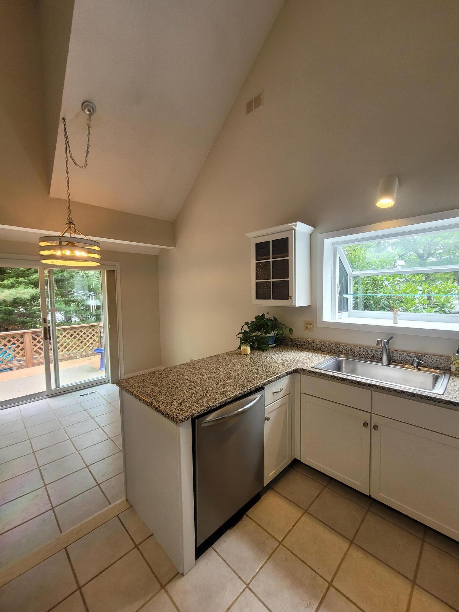 105 Shellback Way, Unit P Mashpee, MA 02649 - Photo 4 of 29 a kitchen with a sink and cabinets
