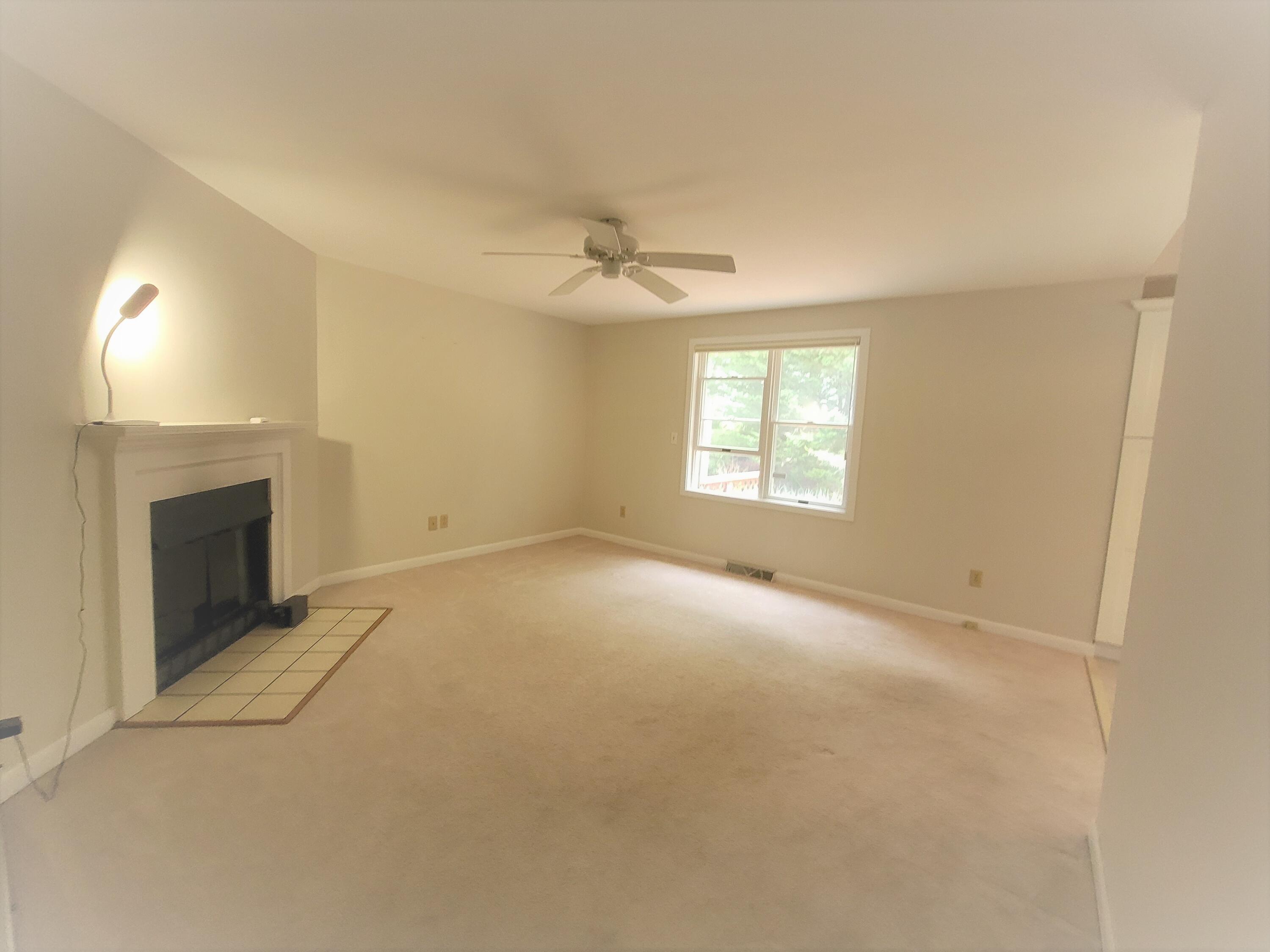 105 Shellback Way, Unit P Mashpee, MA 02649 - Photo 7 of 29 an empty room with windows and fireplace
