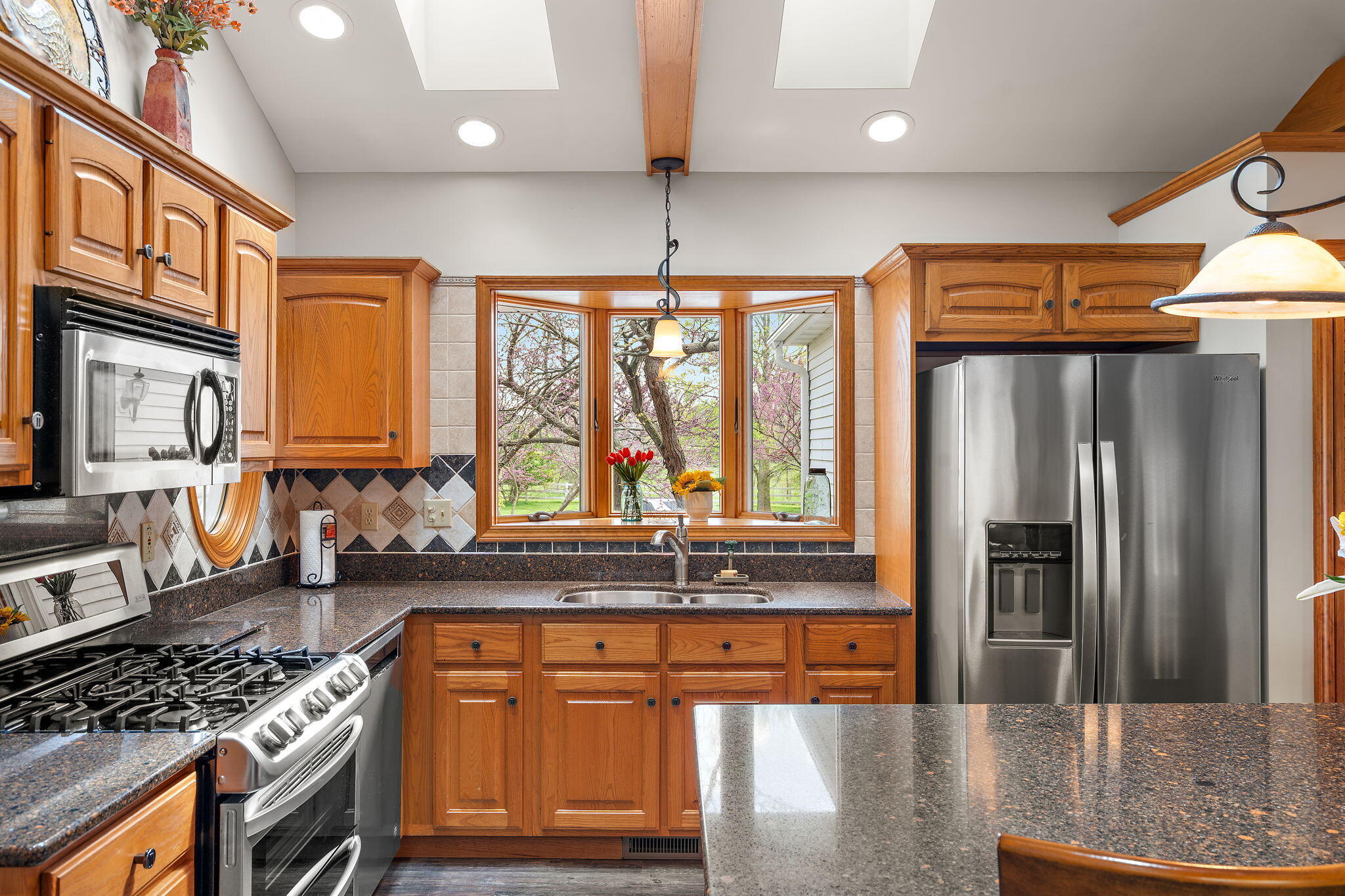 8 Smoke Road Valparaiso, IN 46385 - Photo 12 of 60 a kitchen with stainless steel appliances granite countertop a refrigerator a sink and a stove