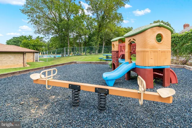 a picture of a bench in front of a wall
