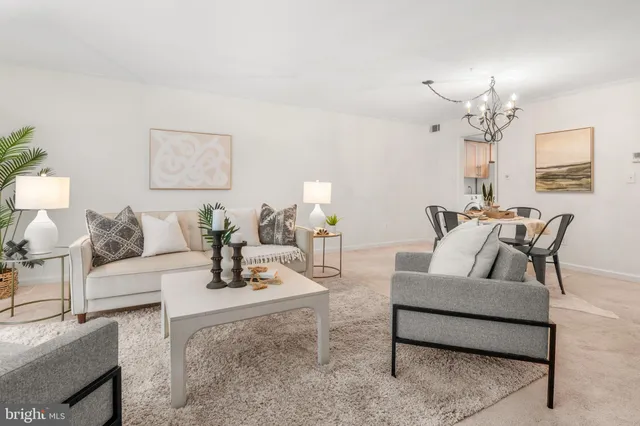 a living room with furniture and a chandelier