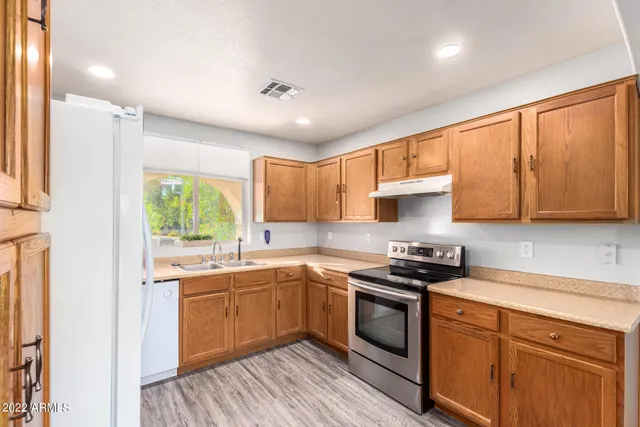 a kitchen with a sink stove and cabinets