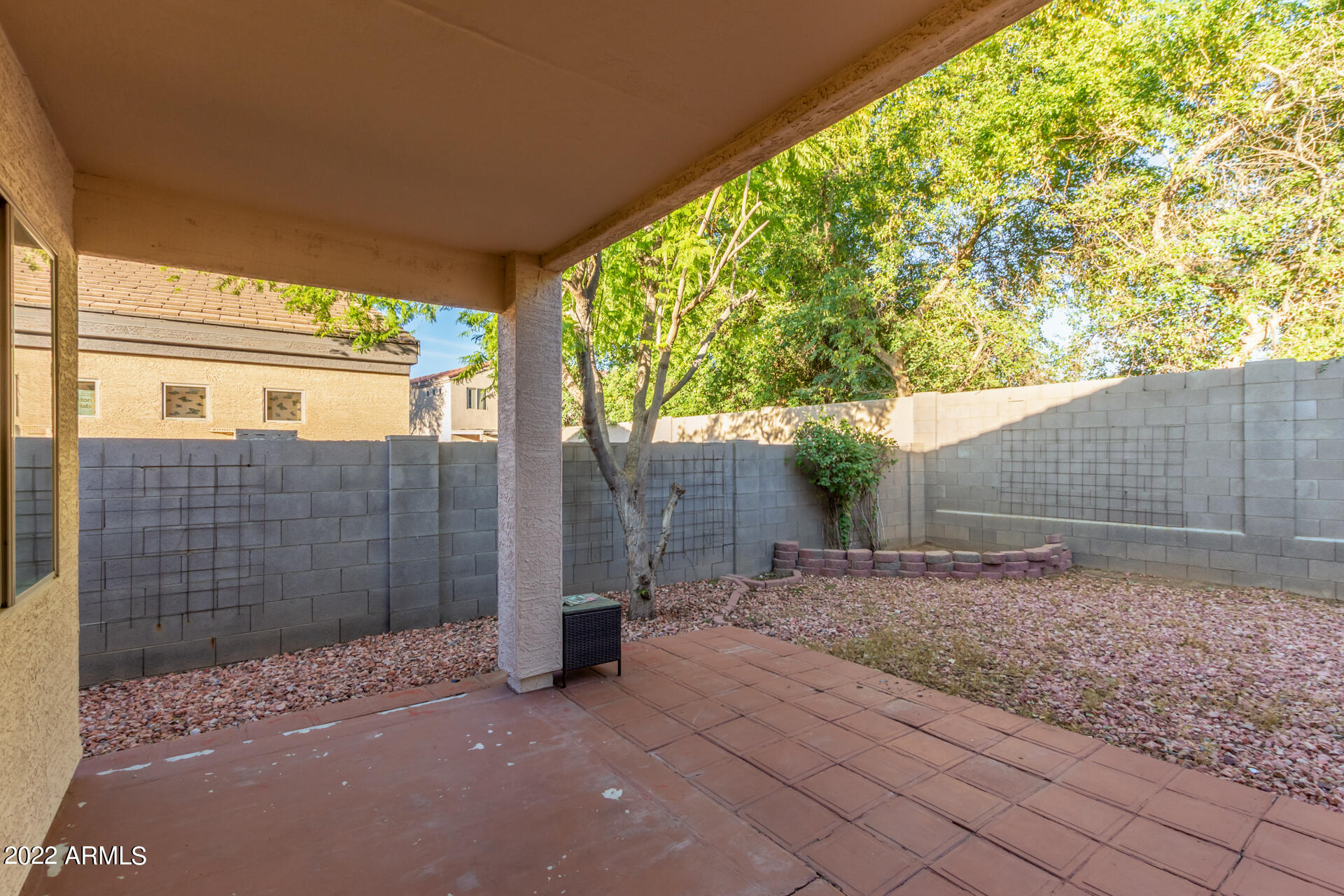 2609 South Devonna Lane Tolleson, AZ 85353 - Photo 27 of 30 a view of backyard with large tree and wooden fence