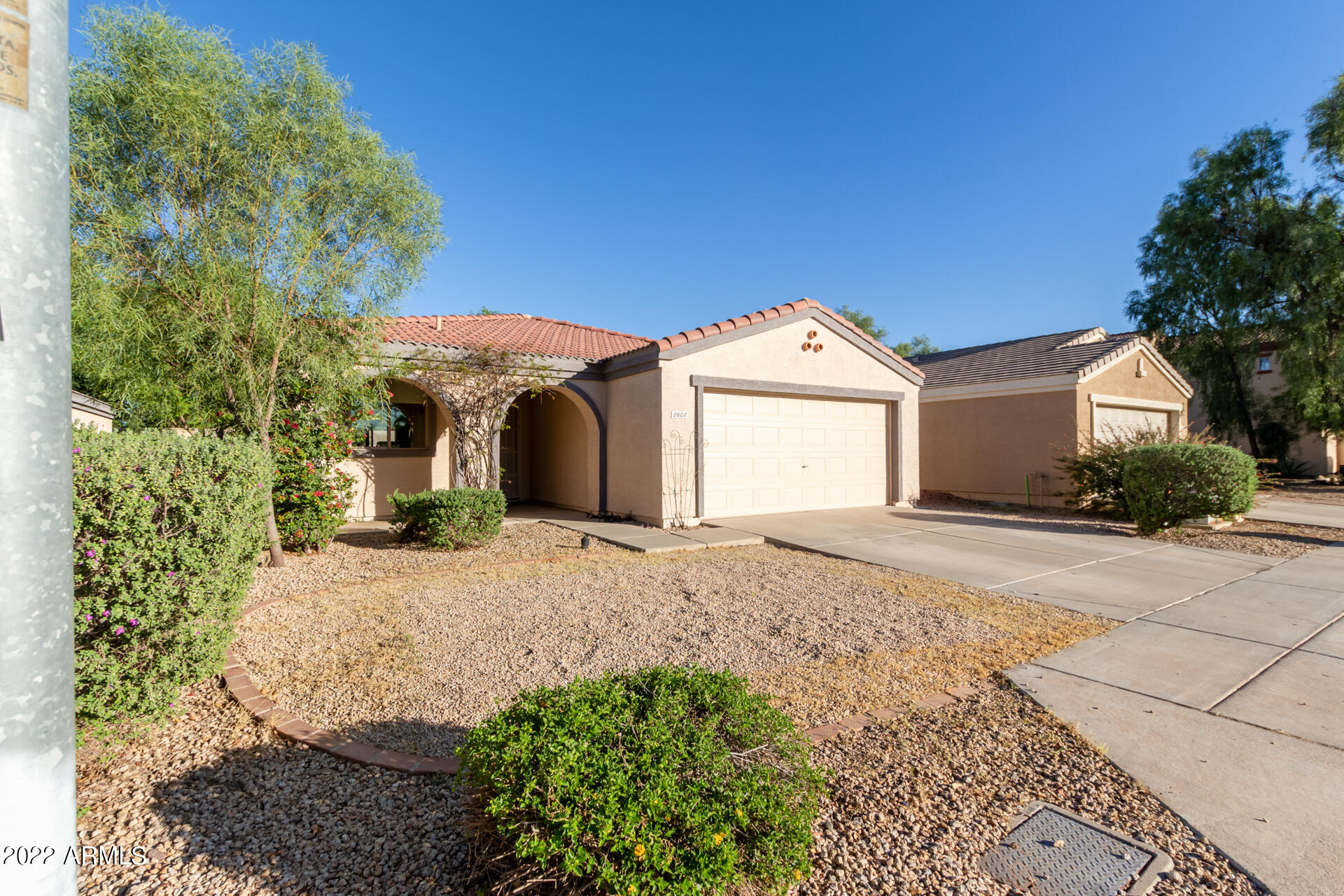 2609 South Devonna Lane Tolleson, AZ 85353 - Photo 3 of 30 a front view of a house with a yard and garage