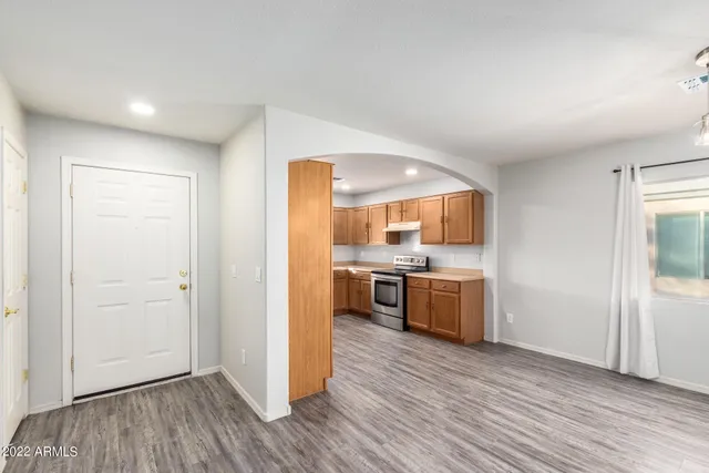 a kitchen with a refrigerator and a stove top oven