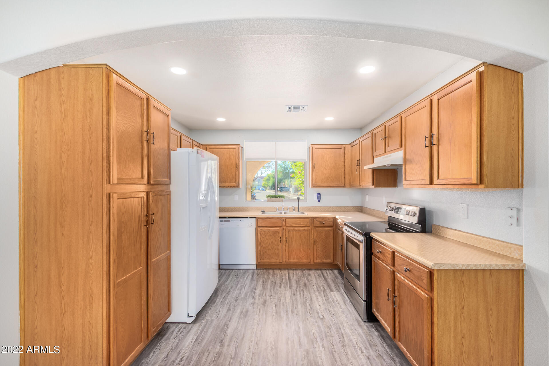 2609 South Devonna Lane Tolleson, AZ 85353 - Photo 10 of 30 a kitchen with a sink appliances cabinets and counter space
