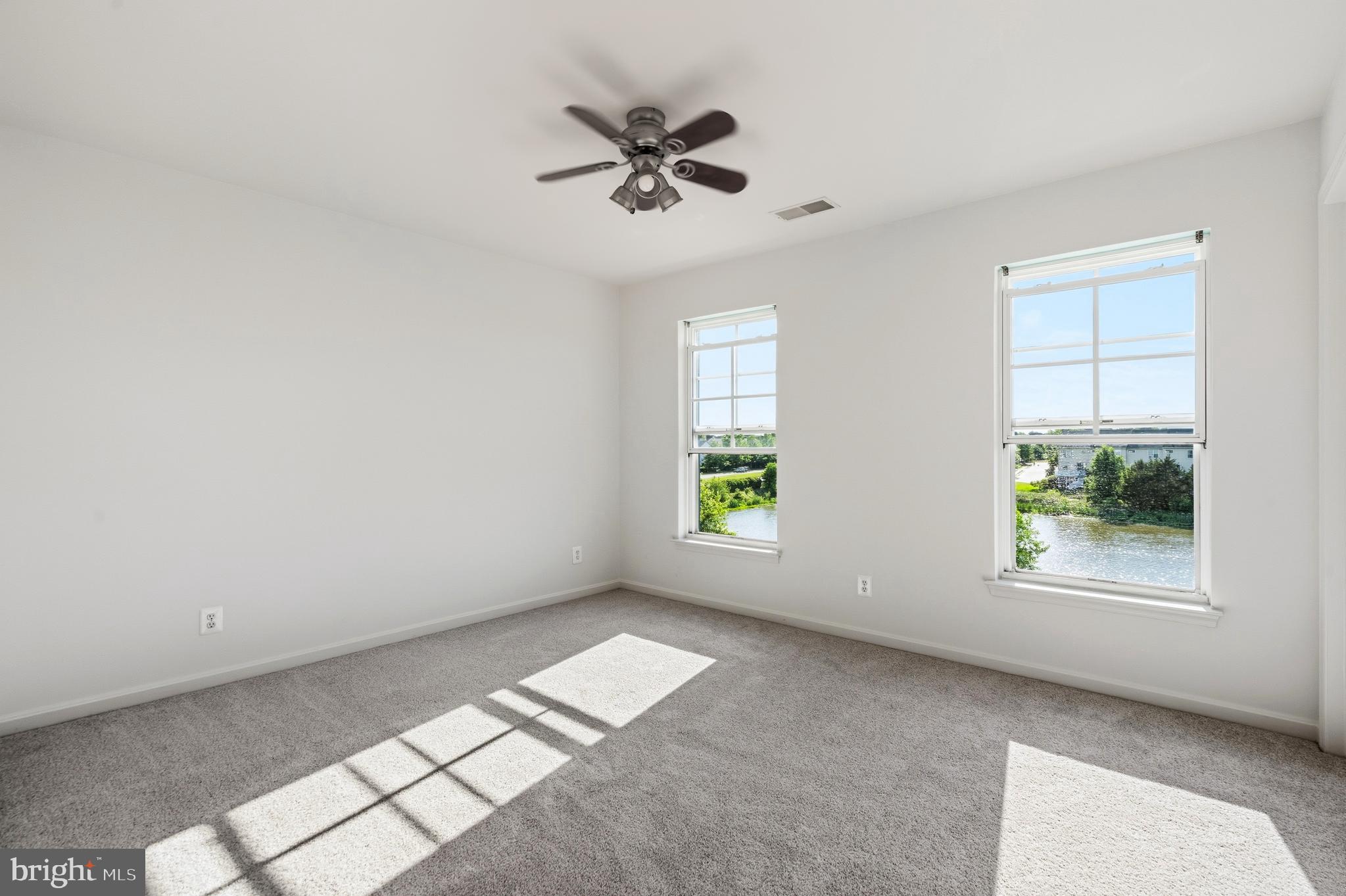 9227 Ribbon Falls Loop Bristow, VA 20136 - Photo 48 of 53 an empty room with windows and ceiling fan