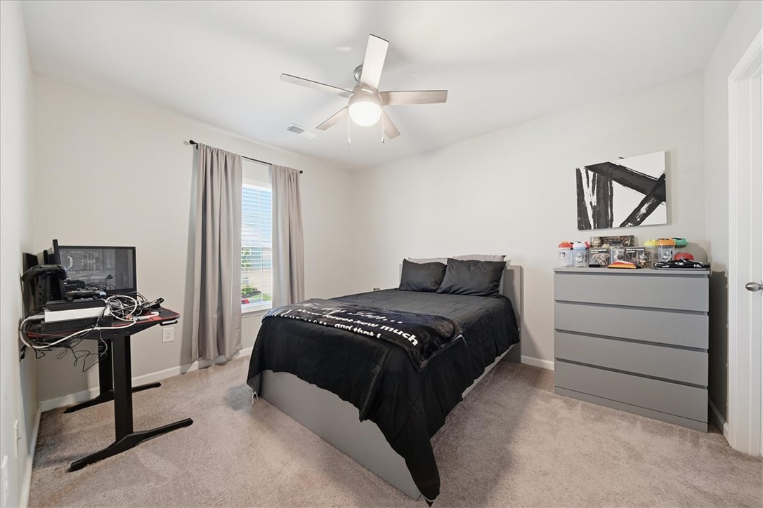208 Grassy Creek Way Pendleton, SC 29670 - Photo 31 of 43 Well-lit sleeping quarters featuring soft carpeting and a bright window with neutral drapes.