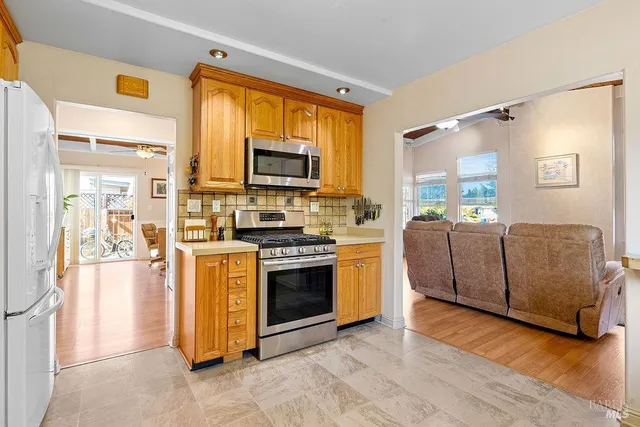 a kitchen with stainless steel appliances a refrigerator sink and cabinets