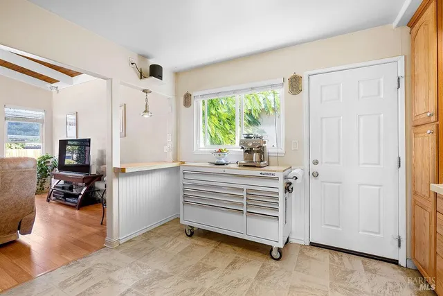 a kitchen with window cabinets and stainless steel appliances