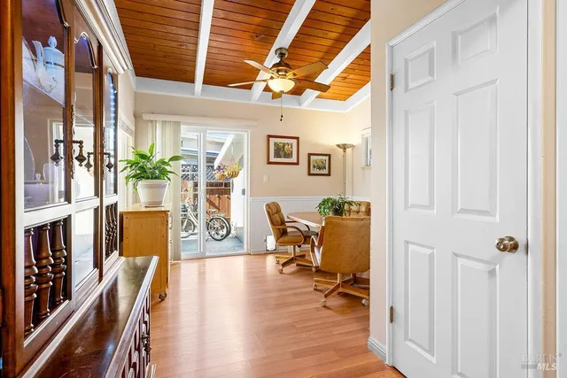 a dining room with furniture and wooden floor