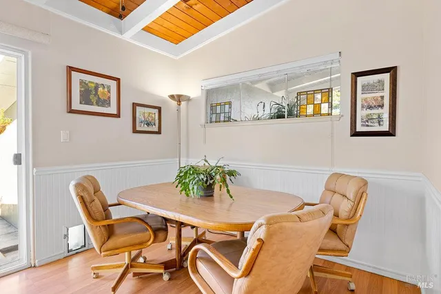 a dining room with furniture and wooden floor