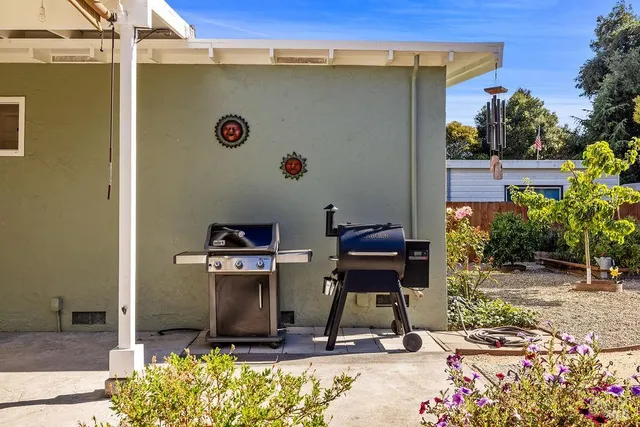 a view of backyard with swimming pool and seating space