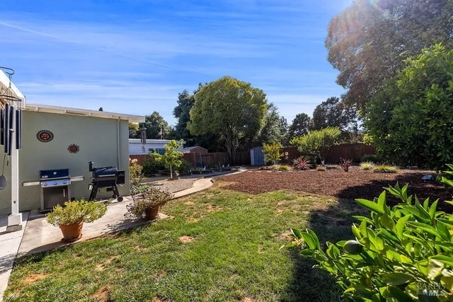 a view of a house with swimming pool and sitting area