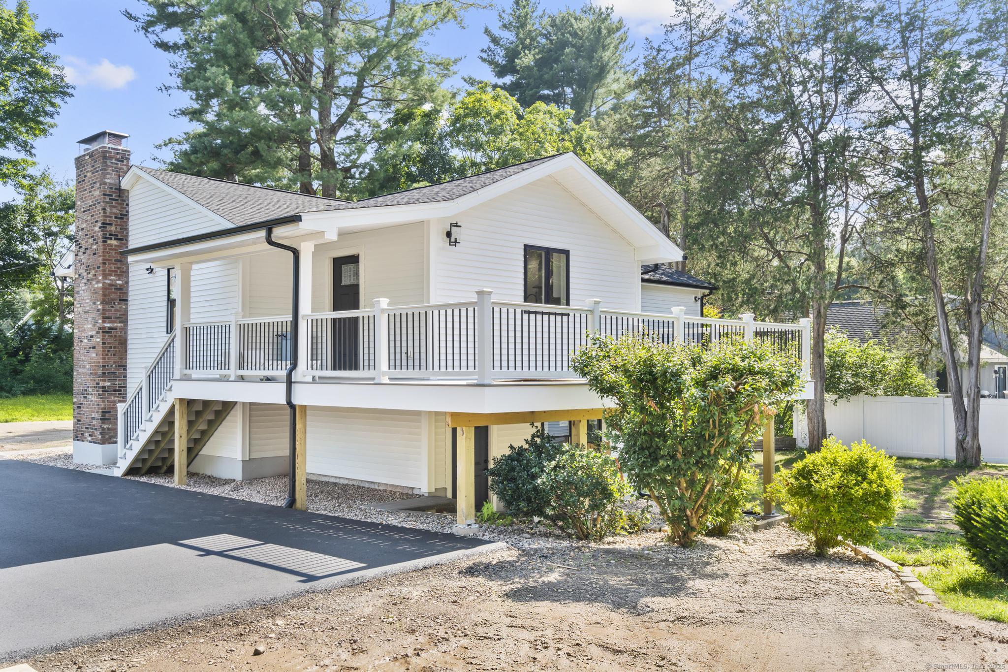 front view of house with a yard and potted plants