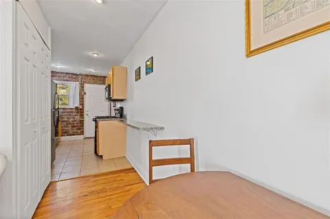 a view of kitchen and utility room with wooden floor