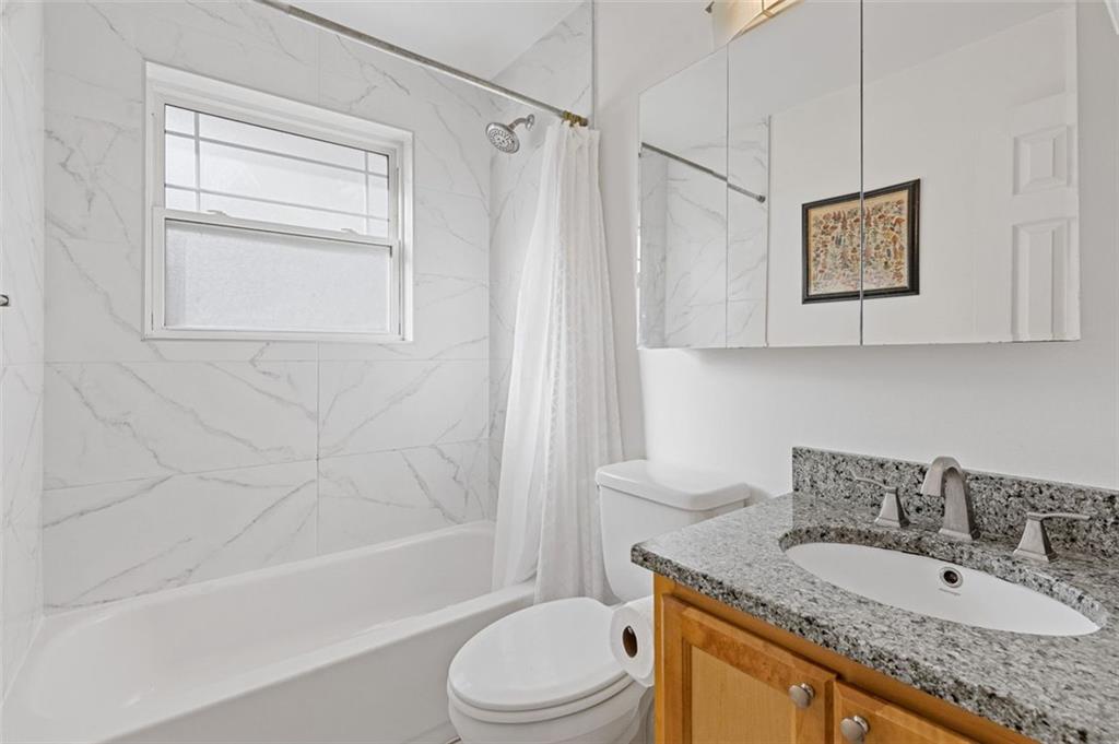 24 Daniel Street Southeast, Unit 12 Atlanta, GA 30312 - Photo 18 of 37 a bathroom with a granite countertop sink toilet and shower