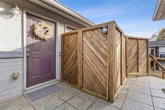a view of a house with a door and wooden walls