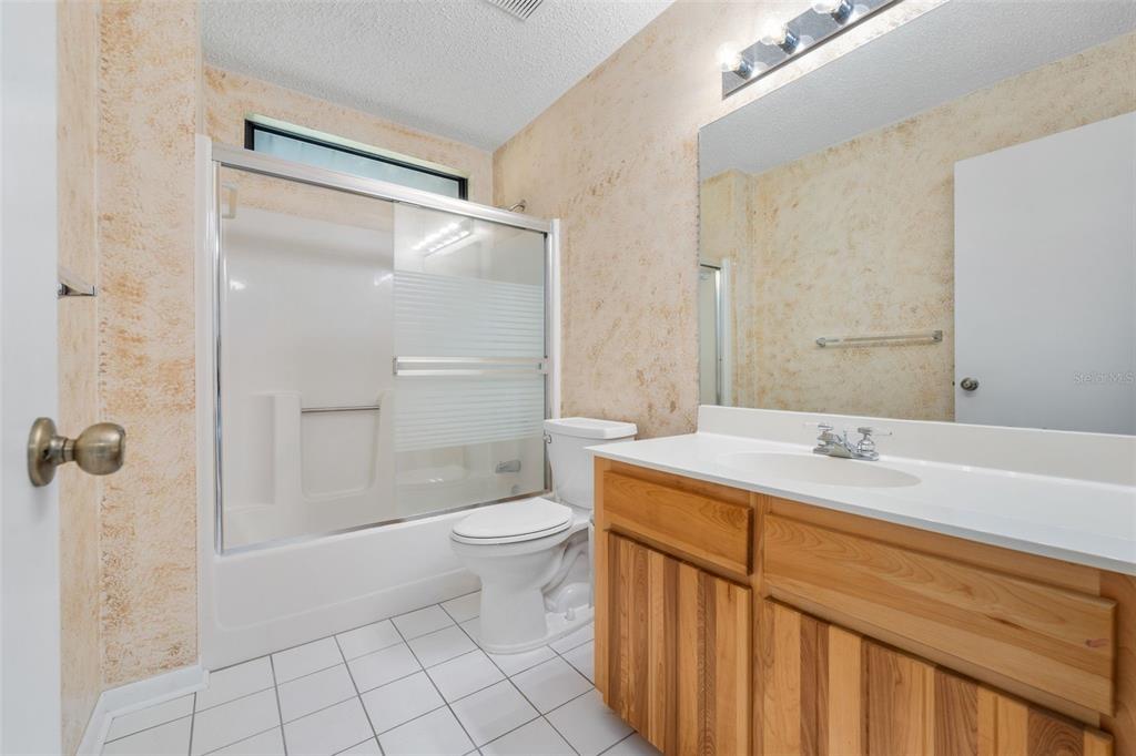 11606 Northwest 120th Terrace Alachua, FL 32615 - Photo 15 of 46 a bathroom with a sink a toilet and shower